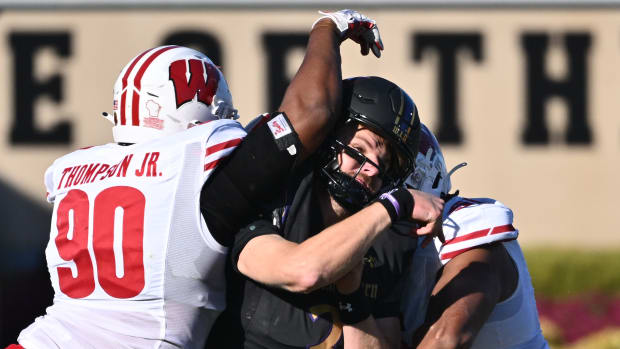 Wisconsin defensive ends James Thompson Jr. and Rodas Johnson hit the Northwestern quarterback.